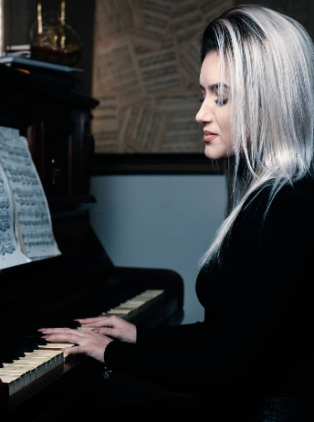 iLo playing the piano in the studio