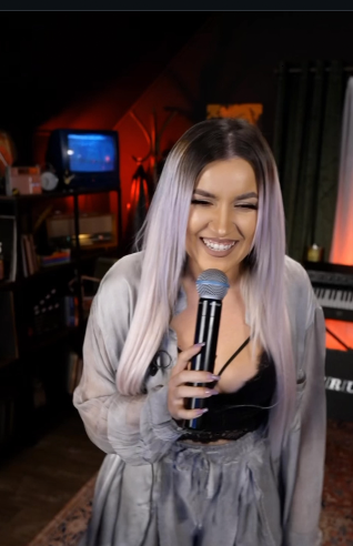 iLo laughing with a microphone in the studio